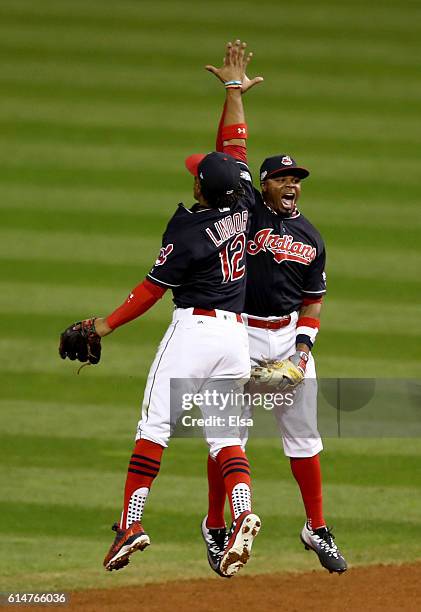 Francisco Lindor of the Cleveland Indians celebrates with teammate Rajai Davis after defeating the Toronto Blue Jays with a score of 2 to 0 in game...