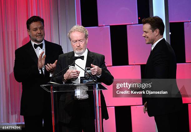 Honoree Sir Ridley Scott accepts the American Cinematheque Award from actors Russell Crowe and Matt Damon onstage at the 30th Annual American...