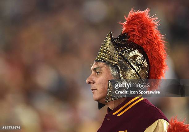 Fan wears a Trojan helmet during an NCAA football game between the California Golden Bears and the USC Trojans at the Los Angeles Memorial Coliseum...