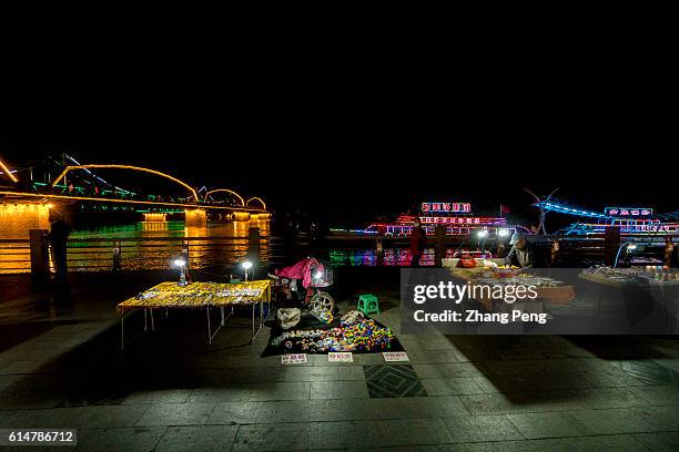 Night market selling North Korea souvenir goods beside the Yalu river. Dandong is the largest Chinese frontier city, bordering with Sinuiju of North...