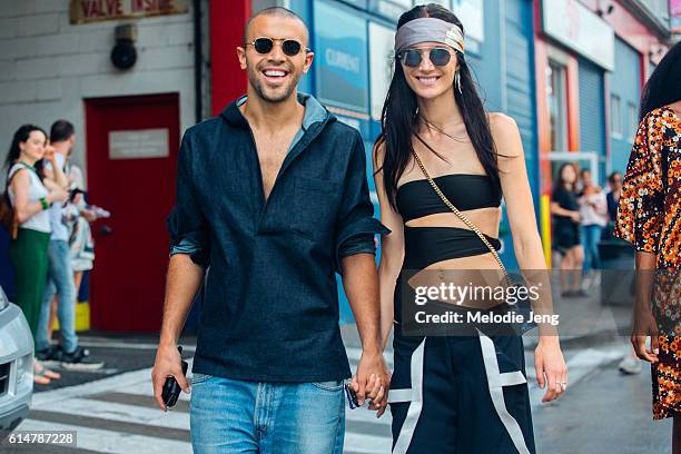 Andrew John Joseph, Janice Alida exit the Dion Lee show at Pier 59 on September 10, 2016 in New York City. Andrew wears a denim hooded top. Janice...