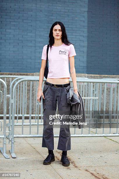 American model Sarah Brannon wears a pink Peel's "painting" t-shirt, dark pants, and Doc Marten style oxford shoes after the Lacoste show at Spring...