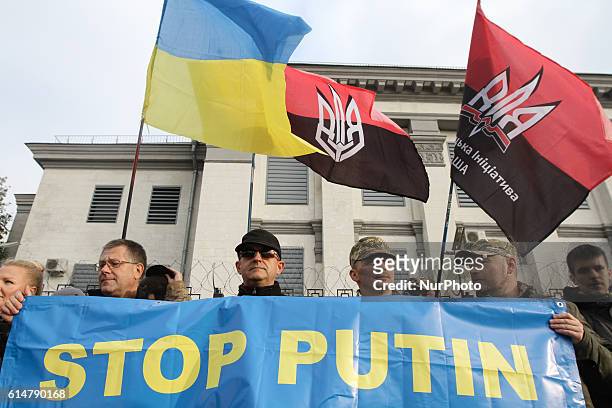 People rally in front of the Russian Embassy building as they take part in an international protest &quot;Stop Putin's War in Ukraine&quot;