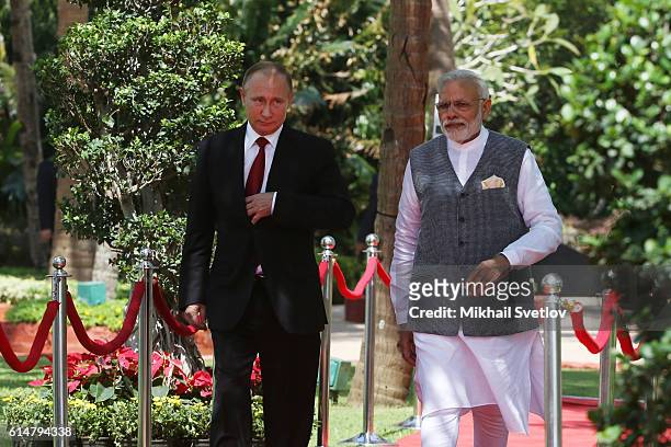 Russian President Vladimir Putin listens to Indian Prime Minister Narendra Modi during their walk at Taj Exotic Hotel on October 2016 in Benaulim,...