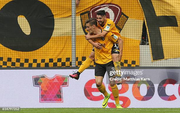 Stefan Kutschke of Dresden jubilates with team mate Aias Aosman after scoring the first goal during the Second Bundesliga match between SG Dynamo...