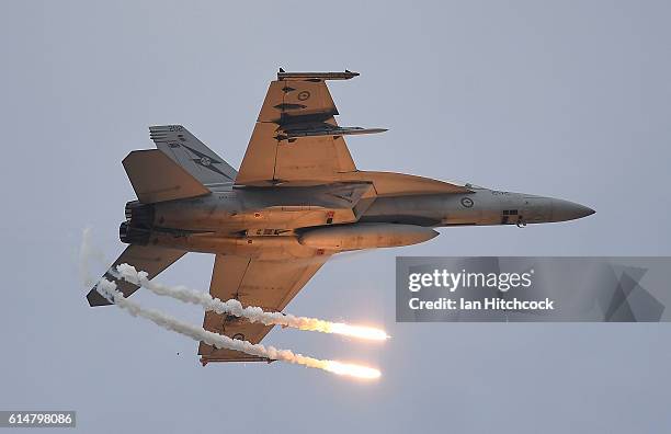 Royal Australian Air Force F/A-18F Super Hornet drops two flares as it performs during the T150 Defence Force Air Show on October 15, 2016 in...