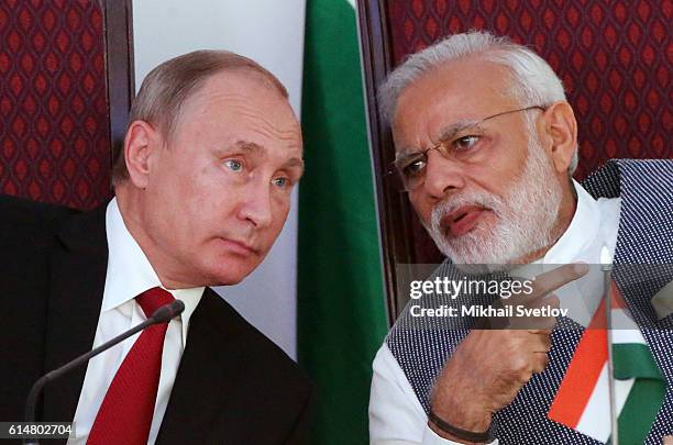 Russian President Vladimir Putin speaks to Indian Prime Minister Narendra Modi during their meeting at Taj Exotic Hotel on October 2016 in Benaulim,...