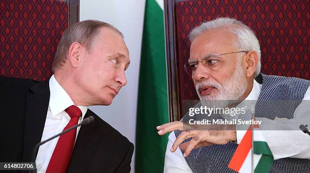 Russian President Vladimir Putin speaks to Indian Prime Minister Narendra Modi during their meeting at Taj Exotic Hotel on October 2016 in Benaulim,...