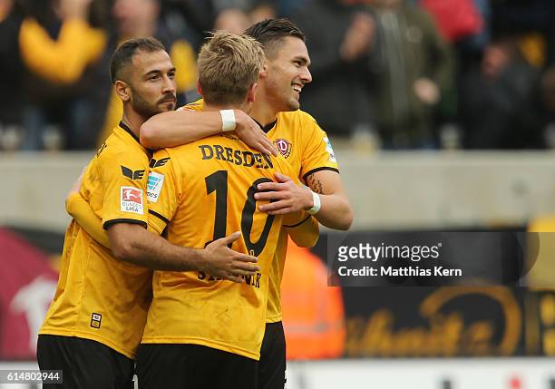 Pascal Testroet of Dresden jubilates with team mate Akaki Gogia and Marvin Stefaniak after scoring the fived goal during the Second Bundesliga match...