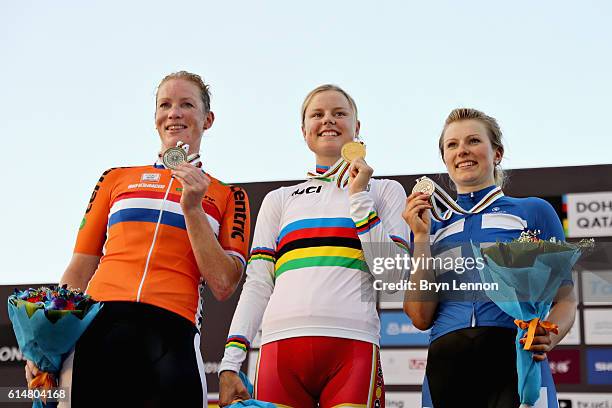 Gold medalist Amalie Dideriksen of Denmark celebrates on the podium with second placed Kirsten Wild of Netherlands and third placed Lotta Lepisto of...