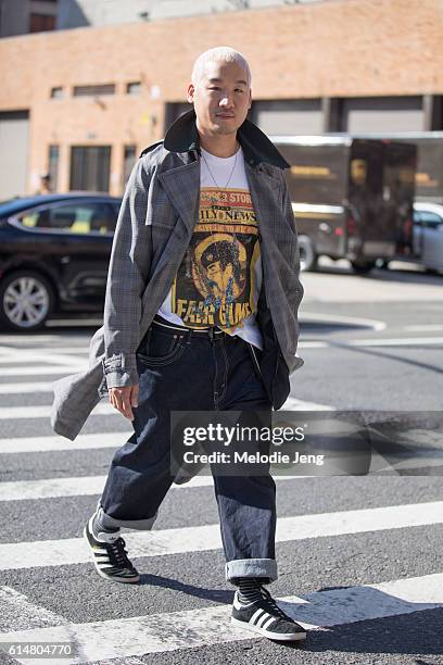 Designer Richard Chai wears a glen check jacket, a graphic "Daily News Fair Game" t-shirt, loose jeans, and Adidas Gazelle sneakers after the 3.1...