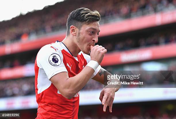 Mesut Ozil of Arsenal celebrates scoring his sides third goal during the Premier League match between Arsenal and Swansea City at Emirates Stadium on...