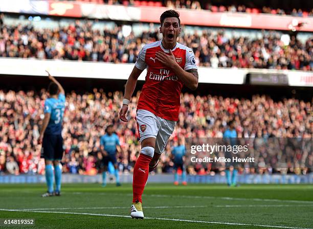 Mesut Ozil of Arsenal celebrates scoring his sides third goal during the Premier League match between Arsenal and Swansea City at Emirates Stadium on...