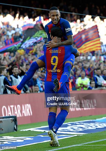Barcelona's Uruguayan forward Luis Suarez celebrates a goal with Barcelona's Brazilian forward Neymar during the Spanish league football match FC...