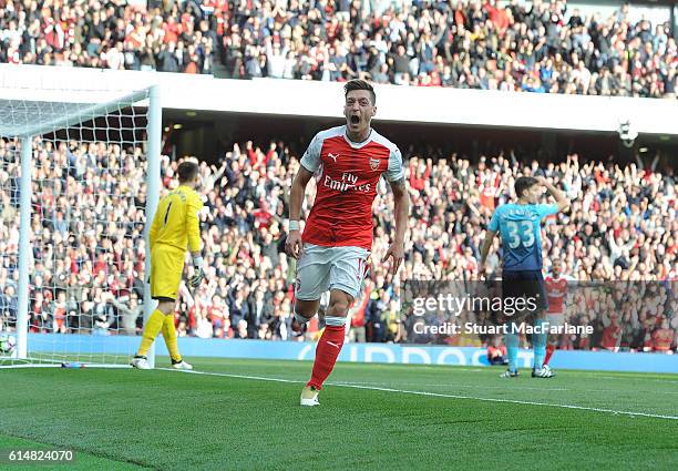 Mesut Ozil celebrates scoring the 3rd Arsenal goal during the Premier League match between Arsenal and Swansea City at Emirates Stadium on October...