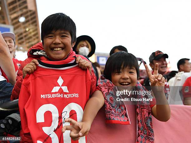 Little fans of Urawa Red Diamonds celebrate their victory after the J.League Levain Cup Final match between Gamba Osaka and Urawa Red Diamonds at the...