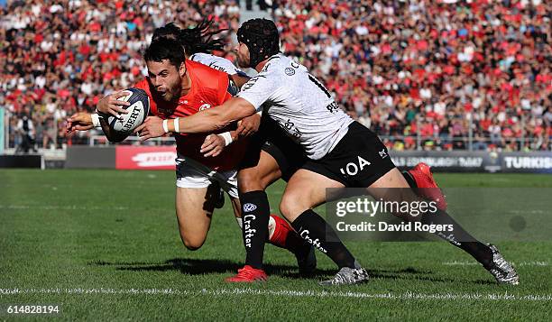 Sean Maitland of Saracens dives over for the first try despite being tackled by Ma'a Nonu and Leigh Halfpenny during the European Rugby Champions Cup...