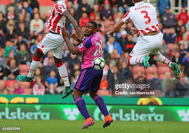 Victor Anichebe of Sunderland sandwiched between Erik Pieters and Bruno Martins Indi of Stoke during the Premier League match between Stoke City and...