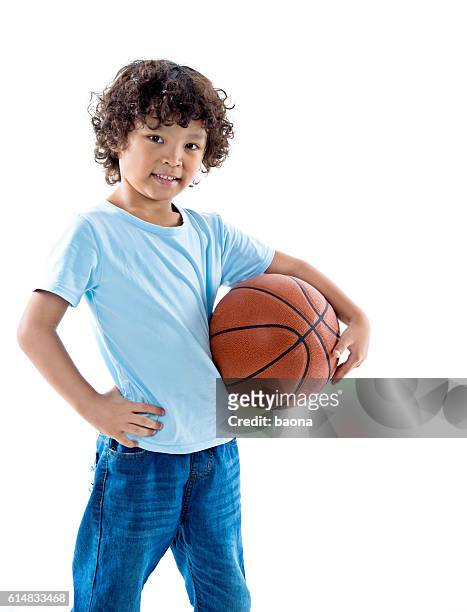 young boy holding a basketball against white background - boys basketball stock pictures, royalty-free photos & images