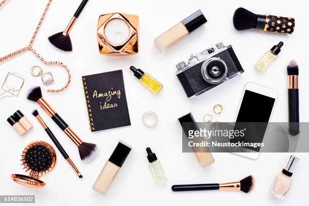 flat lay of beauty products on bloggers desk - fashion accessories stock pictures, royalty-free photos & images