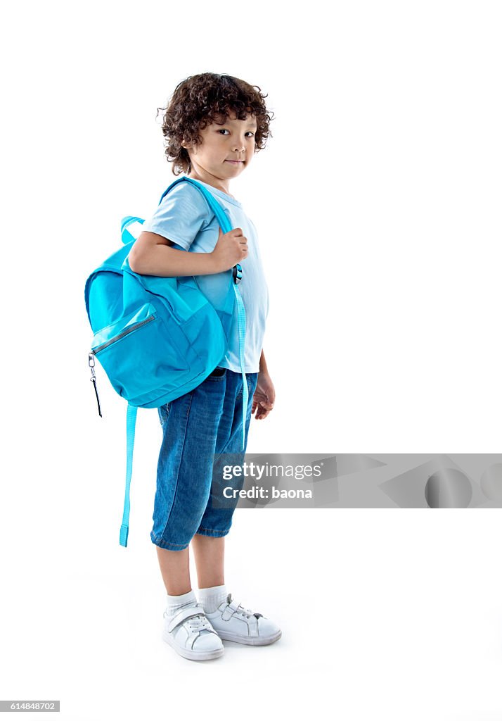 Little asian boy with schoolbag against white background