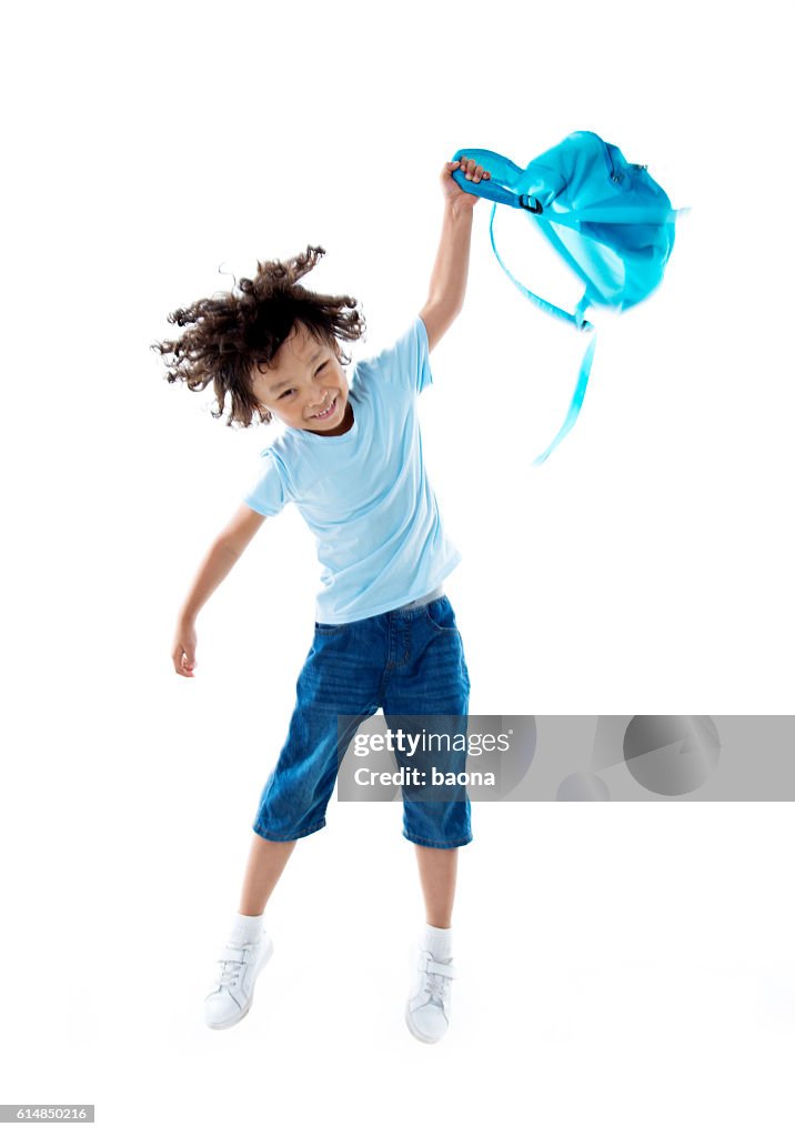 Little asian boy with schoolbag against white background