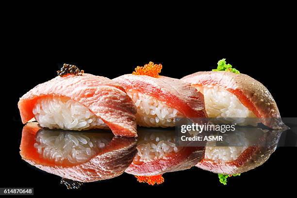 salmon sushi on the blackbackground - sashimi stock pictures, royalty-free photos & images