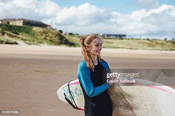 female surfer smiling - surf girl stock pictures, royalty-free photos & images