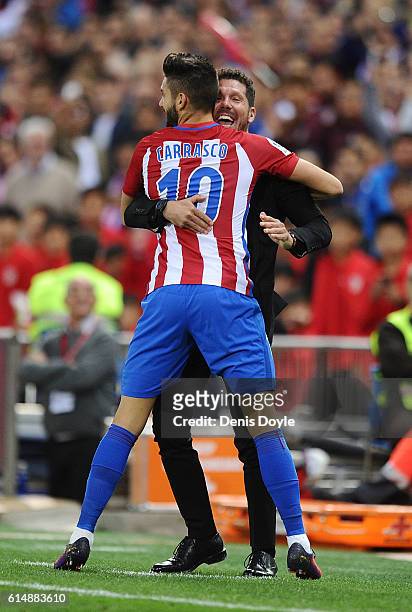 Yannick Carrasco of Club Atletico de Madrid celebrates with his Manager Diego Simeone after scoring his 3rd goal during the La Liga match between...