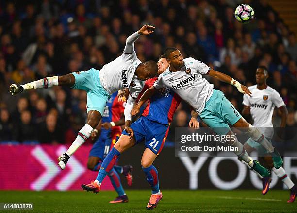 Connor Wickham of Crystal Palace battles with Angelo Ogbonna and Winston Reid of West Ham United during the Premier League match between Crystal...