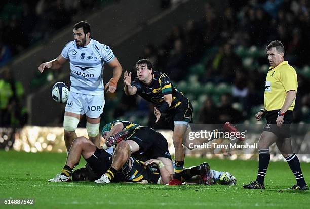 Lee Dickson of Northampton Saints passes out the ball during the European Rugby Champions Cup match between Northampton Saints and Montpellier at...