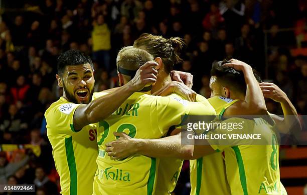 Nantes' Belgian midfielder Guillaume Gillet is congratulated by teammates after scoring a goal during the French L1 football match Lorient vs Nantes,...