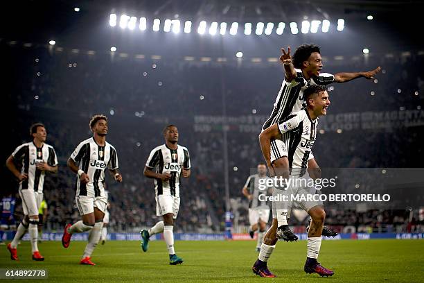 Juventus' forward Paulo Dybala from Argentina celebrates after scoring with Juventus' midfielder Juan Cuadrado from Colombia during the Italian Serie...