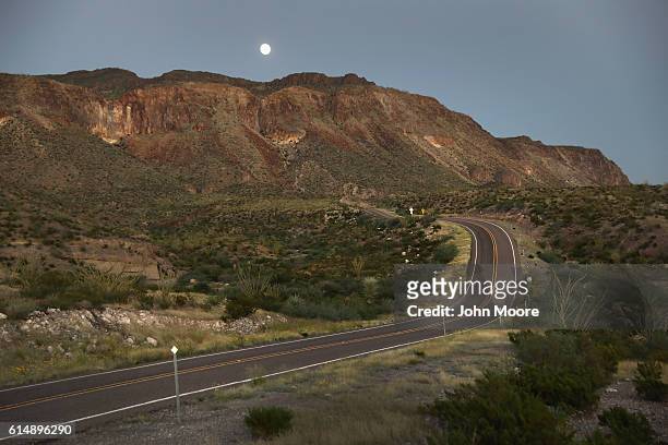 The moon rises over open road in the Big Bend Ranch State Park along the U.S.-Mexico border on October 14, 2016 near Presidio, Texas. The Rio Grande...