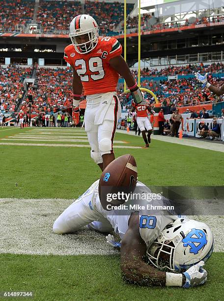 Logan of the North Carolina Tar Heels has a pass broken up by Corn Elder of the Miami Hurricanes during a game at Hard Rock Stadium on October 15,...