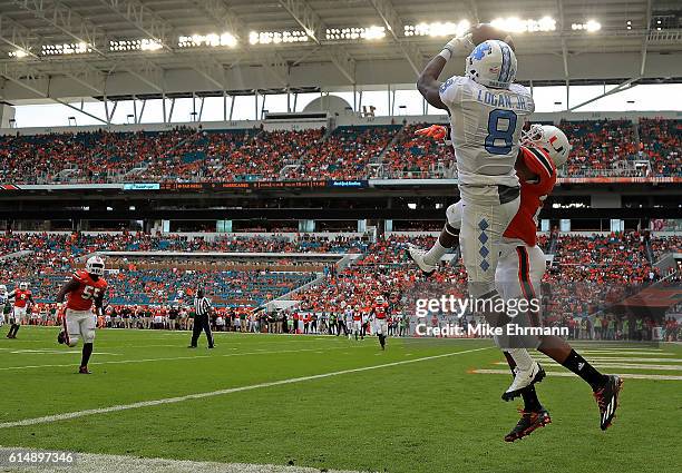 Logan of the North Carolina Tar Heels has a pass broken up by Corn Elder of the Miami Hurricanes during a game at Hard Rock Stadium on October 15,...