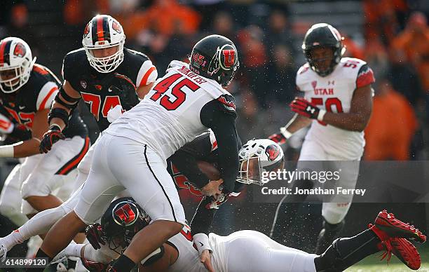 Conor Blount of the Oregon State Beavers is hit by Filipo Mokofisi and Pasoni Tasini of the Utah Utes at Reser Stadium on October 15, 2016 in...