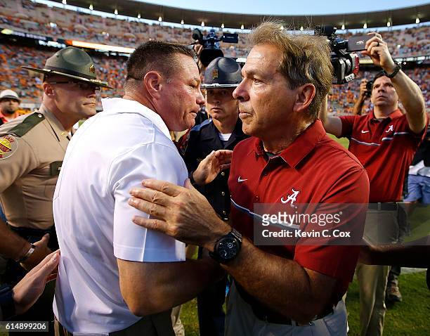 Head coach Nick Saban of the Alabama Crimson Tide shakes hands with head coach Butch Jones of the Tennessee Volunteers after their 49-10 win at...