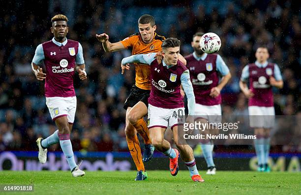 Jack Grealish of Aston Villa is challenged by Conor Coady of Wolverhampton Wanderers during the Sky Bet Championship match between Aston Villa and...