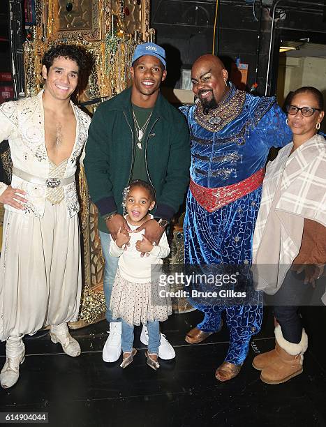 Adam Jacobs as "Aladdin", NY Giants Victor Cruz, daughter Kennedy Cruz, James Monroe Iglehart as "The Genie" and grandmother Blanca Cruz pose...