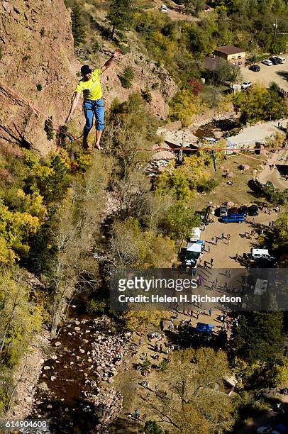 Taylor VanAllen makes the FA, or First Across, high above Eldorado Canyon, on a high-line from the Wind Tower rock formation to the Bastille rock...