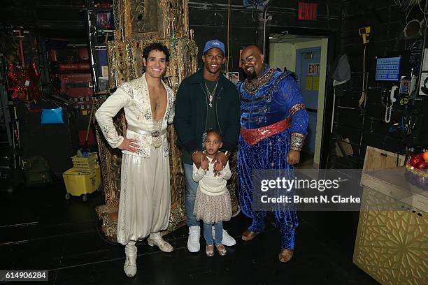 Professional football player Victor Cruz poses for photographs with Adam Jacobs , daughter Kennedy Cruz and James Monroe Iglehart after attending...