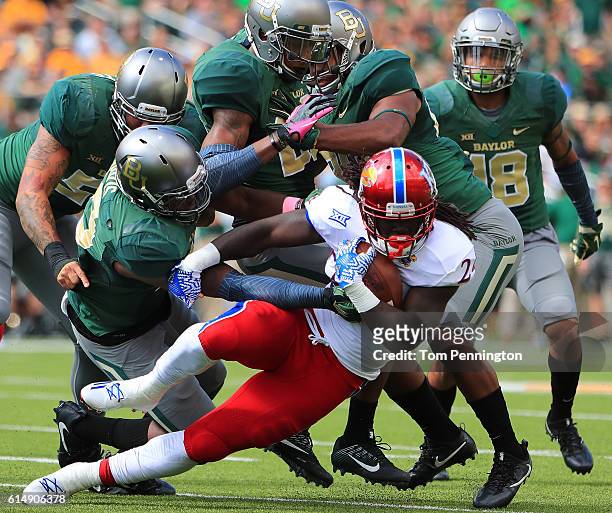 Taylor Martin of the Kansas Jayhawks is stopped for a loss against the Baylor Bears defense in the first half on October 15, 2016 in Waco, Texas.