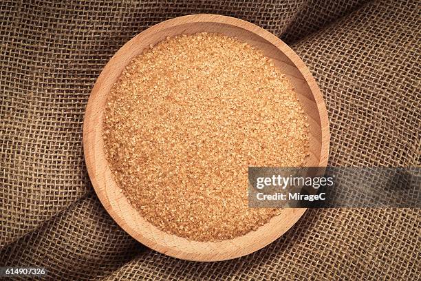 brown sugar in wooden tray, linen material - zucchero di canna foto e immagini stock