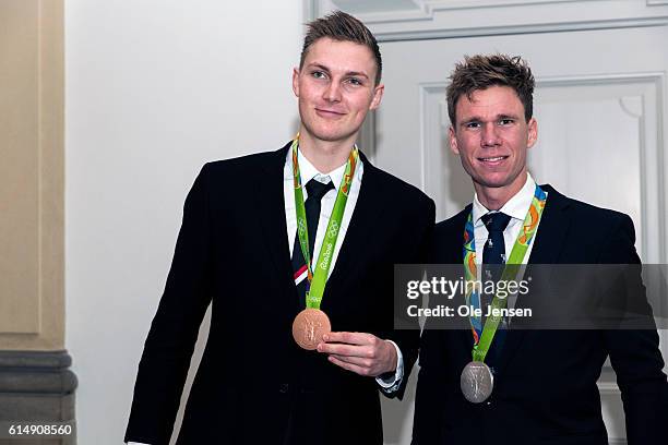 Bronze winner Viktor Axelsen and silver medal winner rower Jacob Barsoe with their medals as they attend a reception hosted by Queen Margarethe of...