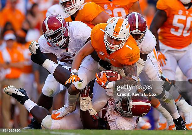 Jalen Hurd of the Tennessee Volunteers is tackled by Joshua Frazier, Dalvin Tomlinson and Shaun Dion Hamilton of the Alabama Crimson Tide at Neyland...