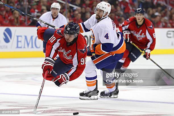 Marcus Johansson of the Washington Capitals is tripped by Dennis Seidenberg of the New York Islanders during the second period at Verizon Center on...