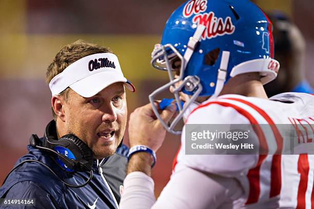 Head Coach Hugh Freeze talks with Chad Kelly of the Mississippi Rebels during a game against the Arkansas Razorbacks at Razorback Stadium on October...