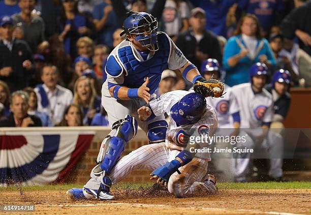Javier Baez of the Chicago Cubs steals home in the second inning as Carlos Ruiz of the Los Angeles Dodgers is unable to make the tag during game one...