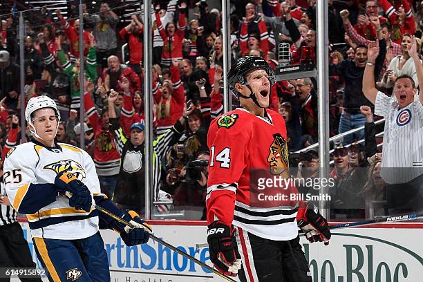 Richard Panik of the Chicago Blackhawks reacts ahead of Matt Carle of the Nashville Predators after scoring the Blackhawks third goal in the first...